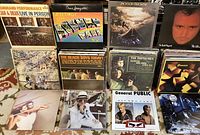 Thirteen album covers including Jan & Dean “Command Performance Live In Person,” Bruce Springsteen “Greetings From Asbury Park, N.J.,” Jackson Browne album, Phil Collins “No Jacket Required,” The Beach Boys “Today!,” The Supremes “Where Did Our Love Go,” Genesis released covers, Elton John “Captain Fantastic and the Brown Dirt Cowboy,” General Public “All the Rage.”