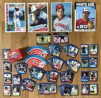 Full layout showing 4 large baseball cards on top and scattered miniature cards and box below with team logo stickers.