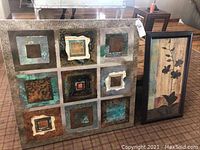 Two framed art pieces: one large 40x40 inch abstract canvas print with nine textured squares, the other a smaller floral print in a dark frame