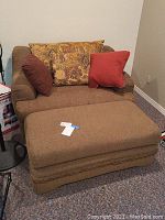 Front view of oversized loveseat with three cushions and matching ottoman in front