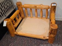 Front view showing three-sided log rail and plywood base