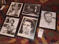 Overview of all five framed black and white movie and TV stills arranged on patterned surface.