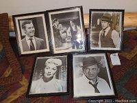 Five framed black-and-white film and TV stills arranged on a patterned surface showing different actors and scenes.