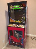 Full view of upright cabinet with marquee and artwork