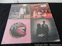 Four vinyl record albums on a black surface showing artwork from Pointer Sisters, Sister Sledge, The Runners, and Phyllis Hyman.