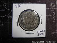 Reverse of 1940 Canadian silver 50 cent coin showing Canadian coat of arms, crown, denomination, and date.