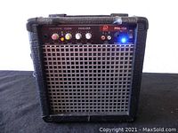 Front view of the PPA-10A amplifier showing control panel, grille, and illuminated power indicator.