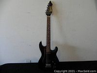 Full front view of the black Nova electric guitar showing body, neck, and headstock.