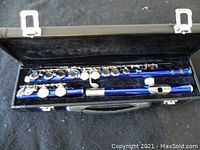 Blue Slade flute disassembled in three parts inside a fitted black hard case with silver latches