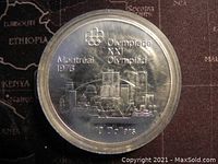 Reverse side showing Montreal skyline, Olympic emblem, and 10 Dollars inscription.