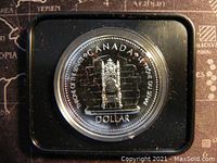 Close-up of the reverse side of the 1977 Canadian Silver Jubilee $1 proof coin showing the throne design and inscriptions.