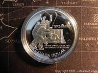 Front side of the silver proof coin showing hockey players celebrating a goal with the inscription 1972-1997 and Canada dollar text.