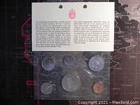 Top view of all six coins sealed in their plastic holders with certificate describing the set's proof-like quality and commemorative context for the 100th anniversary of the Royal Canadian Mounted Police.