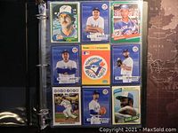 Photo of 9 Toronto Blue Jays baseball trading cards in a clear plastic sleeve showing various players and a team logo card.