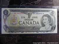 Front side of 1973 Canadian 1 dollar banknote showing Queen Elizabeth II, serial number, and Canadian coat of arms.