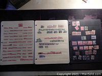 Three album pages displaying a collection of Newfoundland stamps in red, purple, and pink colors, arranged neatly in rows.