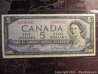 Front of 1954 Canadian five dollar banknote showing Queen Elizabeth II and serial number.