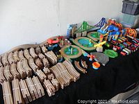 Overview of multiple wooden track pieces, bridges and accessories laid out on a table