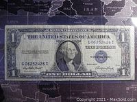 Front side of 1935E US Silver Certificate 1 Dollar Banknote showing full note on a dark map background.