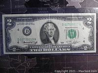 Front side of the 1976 US two-dollar banknote showing portrait of Thomas Jefferson, serial number D02733213A, and detailed engraving with Treasury seal.