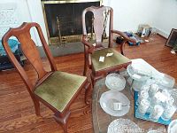 Two chairs (one side chair, one armchair) positioned in living room for overall lot view