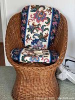 Full front view of wicker chair showing the full cushion and structure