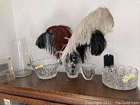 Wide photo overview showing all items including feathers in Waterford vase, two cut glass bowls, and pitcher