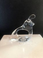 Single clear acrylic quail shaped napkin ring viewed from side, showing the overall shape and smooth transparent material.