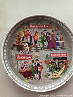 Top side of the circular metal tray showing colorful colonial era styled men and women enjoying beer in various scenes and the Knickerbocker branding.