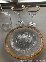 Image showing 2 gilded edge cocktail coupes, matching gilded glass platter, and clear glass decanter without stopper.
