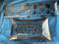 Both serving pieces shown together on blue fabric background, showing the overall size and design of the bowl and tray.