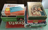 Stack of six boxed vintage games and magic set including Rolomatic Bridge, Quinto, Dr. Who game, Mysto Magic, Behind the '8' Ball, and Run Yourself Ragged.