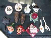 Photo of 13 assorted vintage wall hangings including McCoy apple wall pocket, 1950s violin, Asian vases, ceramic heads, plaques, cast iron hooks, and wooden painted string holders.