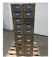 Front view of the steel parts cabinet showing 20 drawers, label holders, and wear on metal.