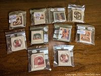 Photo showing various Sportflics baseball trading cards featuring team logos from different MLB teams, each individually bagged with handwritten labels showing team names, year 1987, and league American or National.