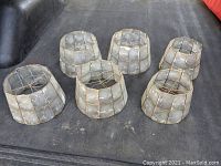 Image showing all six vintage capiz shell lampshades arranged together on a dark surface.