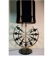 Mid-Century brass crescent table lamp showing full height with original black fabric shade with gold tassel trim.