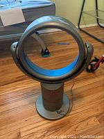 Zoomtec round bladeless fan showing front full view with fan ring and base on hardwood floor.