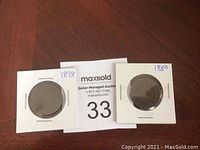 Two large Canadian pennies in protective holders, labeled 1898 and 1859.