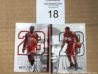Two basketball rookie cards side by side featuring Michael Jordan (1984-1985) and LeBron James (2003-2004) with respective team uniforms and numbers.