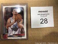 Front of card in protective case with lot tag visible