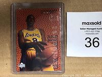 Front of card in plastic sleeve showing Kobe Bryant image and auction tag #36
