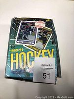 Front view of the 1990-91 O-Pee-Chee hockey card box showing Bill Ranford and Cam Neely images along with the MaxSold auction tag number 51.