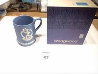 Blue Wedgwood Jasperware Olympic commemorative mug with original box, showing front and side details of white relief decoration.