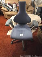 Front view of gray ergonomic office chair with contoured backrest and cushioned seat.