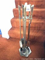 Full view of the set showing all five tools on the hexagonal stand with antique brass finish.