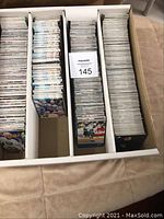 Wide view of four dividers filled with hockey cards in a cardboard box