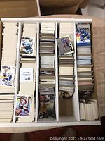 Top-down view of box filled with stacks of hockey cards separated by cardboard dividers.