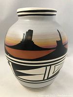 Front side view of the Navajo pottery vase showing painted desert landscape and geometric patterns