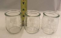 Three clear glass jars shown with a tape measure indicating height of approximately 3 inches.
